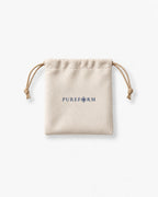 Ivory velvet Pureform drawstring pouch with navy wordmark and champagne cords
