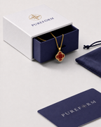 Pureform charm necklace, burgundy red clover with a polished gold finish