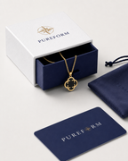 Pureform charm necklace, onyx black clover with a polished gold finish