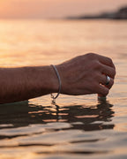Silver Cuban tag bracelet and Ocean Ring worn at the sea at sunset