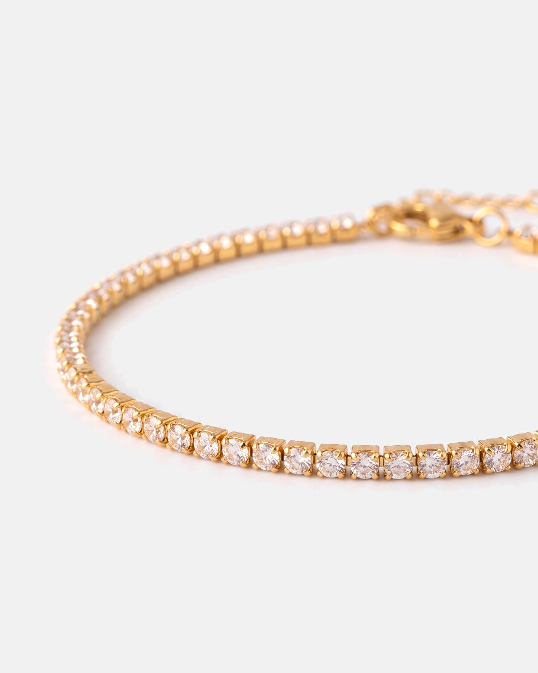 Close-up of the fine gold prong-set stones and lobster clasp of the Fine Tennis Bracelet