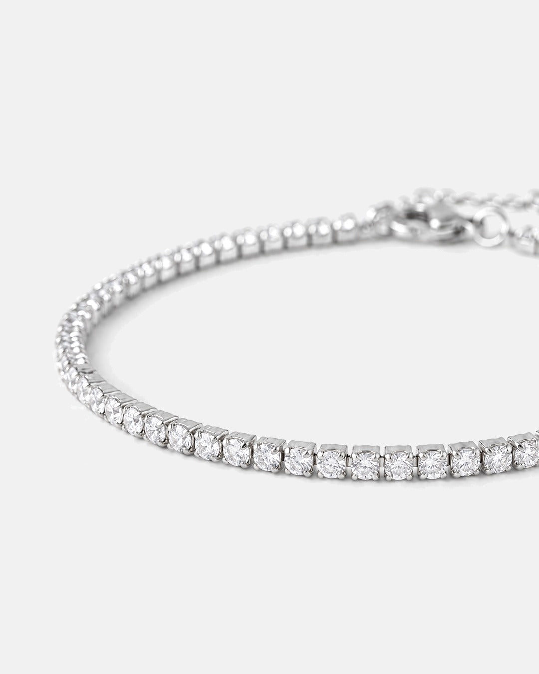 Close-up of the fine silver prong-set stones and lobster clasp of the Fine Tennis Bracelet
