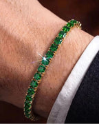 Deep emerald green square-cut stones against warm 18K gold plating