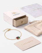 January birthstone bracelet in 14K gold, Siam red and emerald green stones with Pureform gift packaging