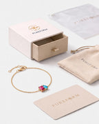 July birthstone bracelet in 14K gold, rose pink and aquamarine blue stones with Pureform gift packaging