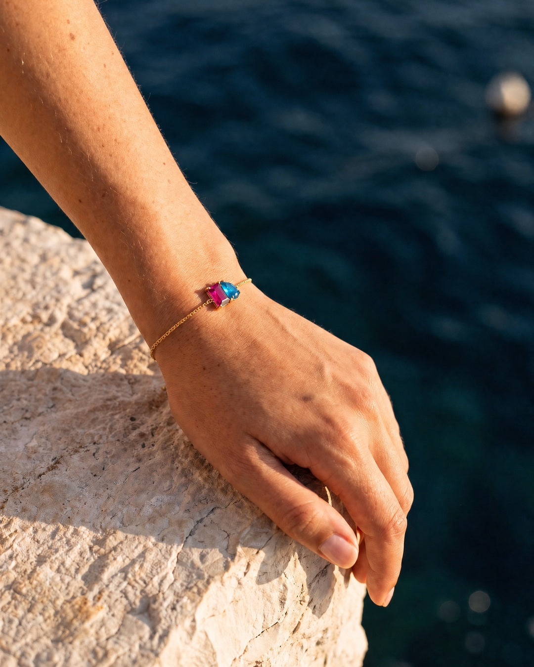 July birthstone bracelet in 14K gold, rose pink and aquamarine blue stones, worn