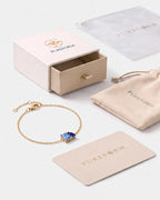 March birthstone bracelet in 14K gold, light sapphire blue and sapphire blue stones with Pureform gift packaging