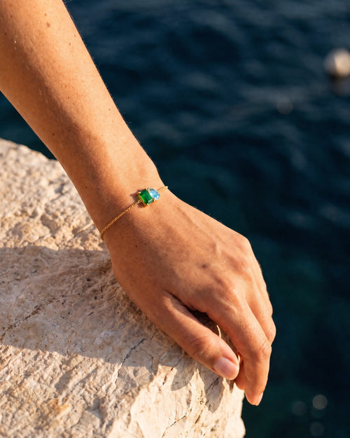 May birthstone bracelet in 14K gold, emerald green and aquamarine blue stones, worn
