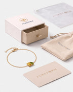 November birthstone bracelet in 14K gold, jonquil yellow and peridot green stones with Pureform gift packaging