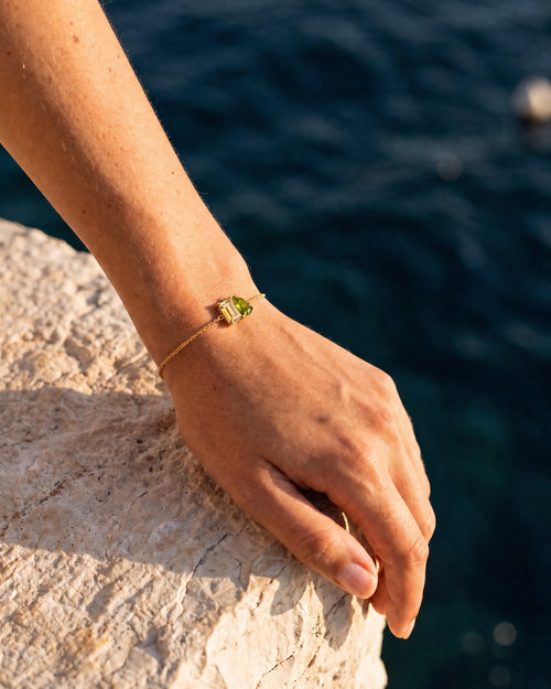 November birthstone bracelet in 14K gold, jonquil yellow and peridot green stones, worn