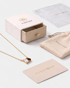April birthstone necklace in 14K gold, clear crystal and Siam red stones with Pureform gift packaging