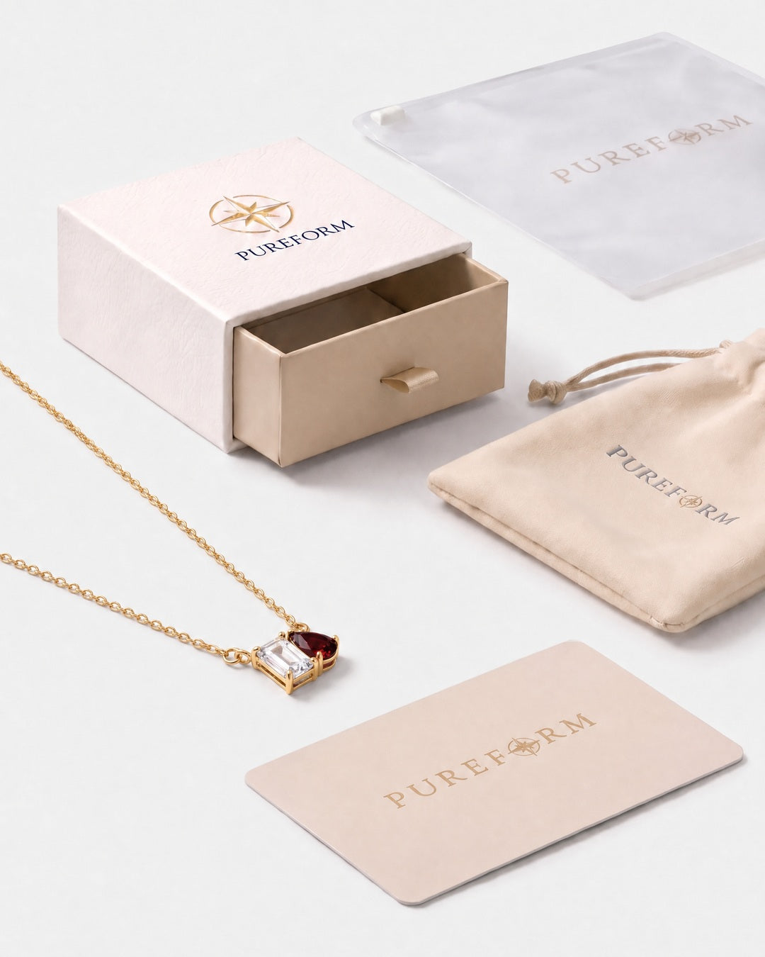 April birthstone necklace in 14K gold, clear crystal and Siam red stones with Pureform gift packaging