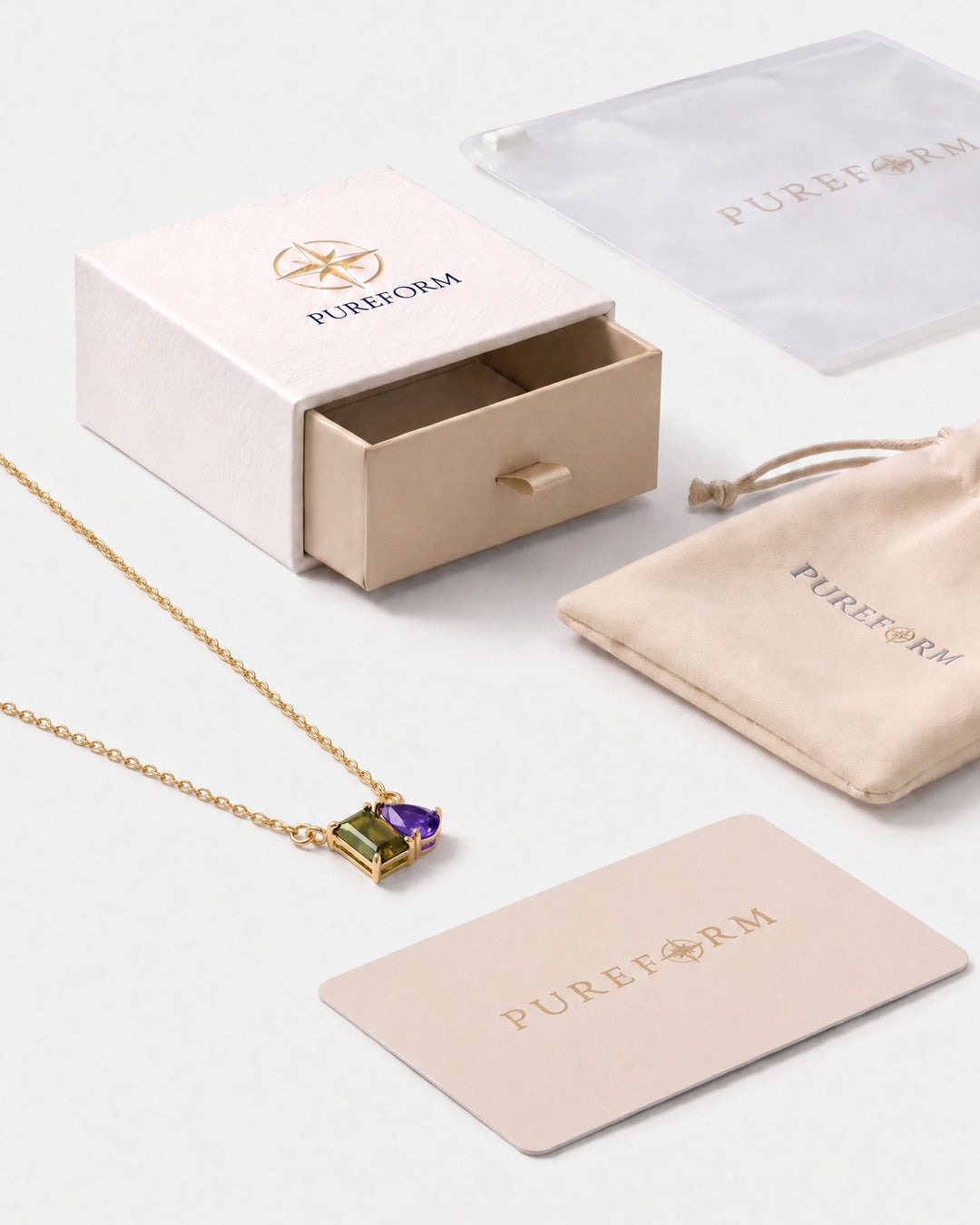 August birthstone necklace in 14K gold, peridot green and violet stones with Pureform gift packaging