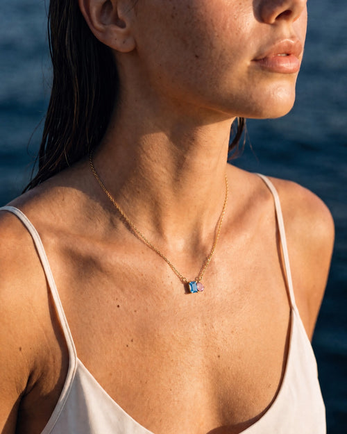 December birthstone necklace in 14K gold, aquamarine blue and light rose stones, worn