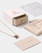 February birthstone necklace in 14K gold, violet and jonquil yellow stones with Pureform gift packaging