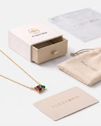 January birthstone necklace in 14K gold, Siam red and emerald green stones with Pureform gift packaging