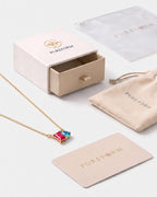 July birthstone necklace in 14K gold, rose pink and aquamarine blue stones with Pureform gift packaging