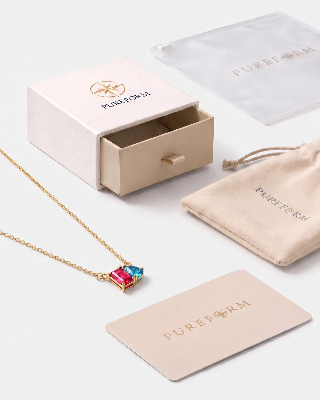 July birthstone necklace in 14K gold, rose pink and aquamarine blue stones with Pureform gift packaging