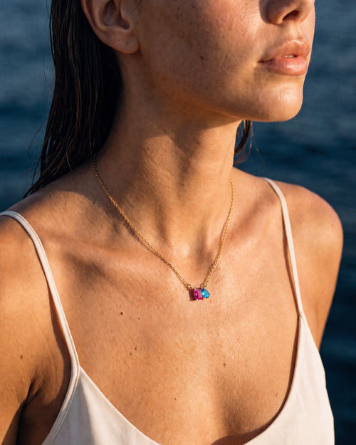 July birthstone necklace in 14K gold, rose pink and aquamarine blue stones, worn
