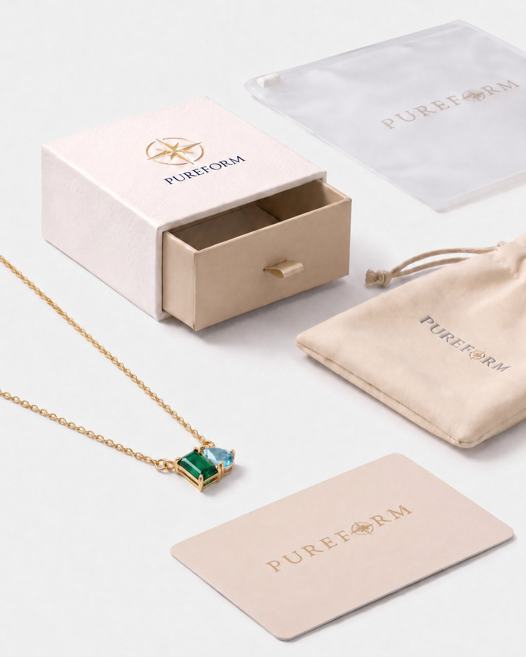 May birthstone necklace in 14K gold, emerald green and aquamarine blue stones with Pureform gift packaging