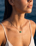 May birthstone necklace in 14K gold, emerald green and aquamarine blue stones, worn