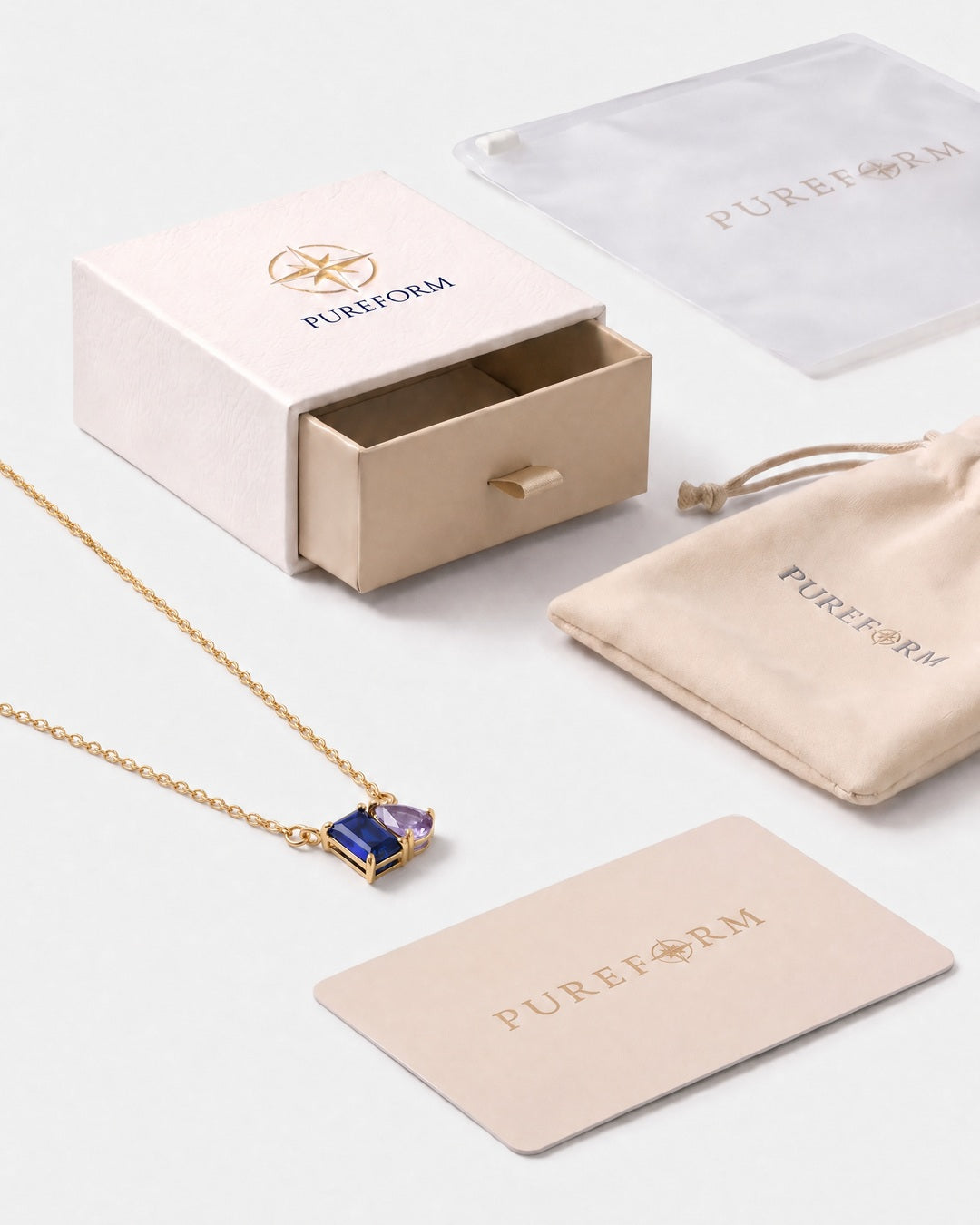 September birthstone necklace in 14K gold, sapphire blue and light amethyst stones with Pureform gift packaging