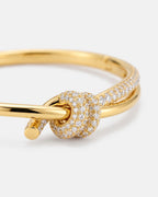 Close-up of the pavé knot on the gold bangle