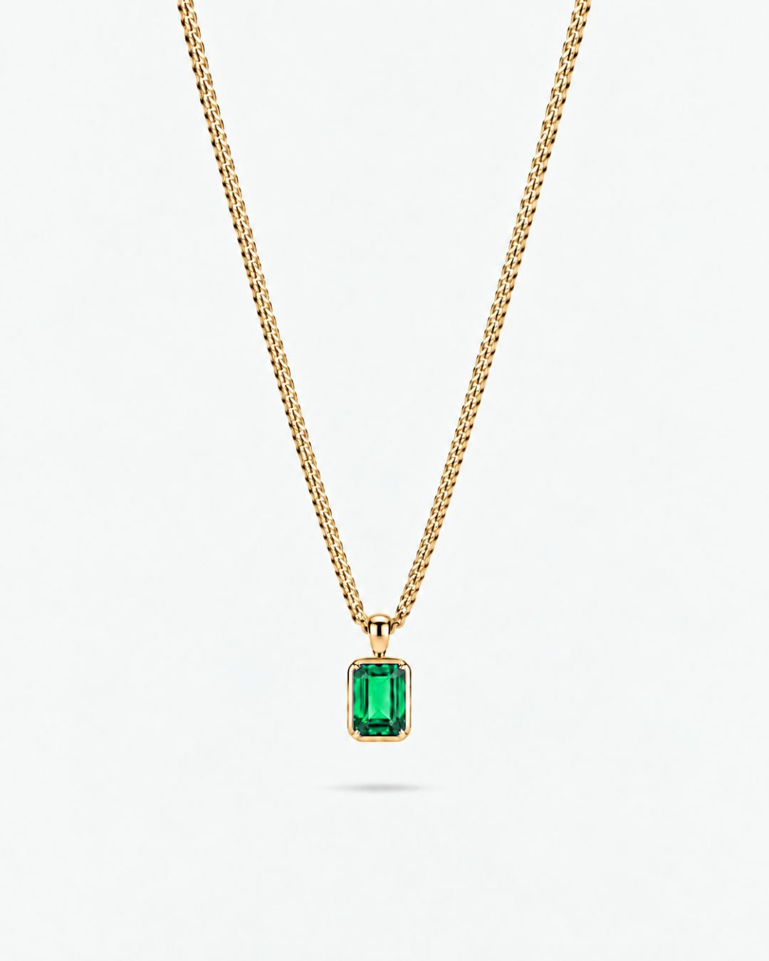 Emerald pendant necklace, 1 carat, 18K gold — studio packshot on white