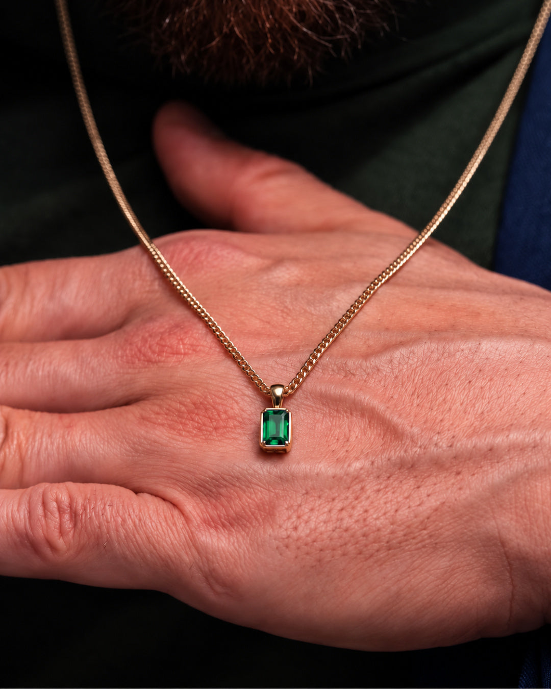 Emerald pendant necklace, 2 carat, 18K gold — shown in hand for scale