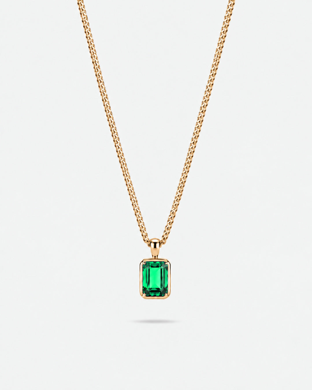 Emerald pendant necklace, 2 carat, 18K gold — studio packshot on white
