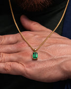 Emerald pendant necklace, 3 carat, 18K gold — shown in hand for scale