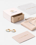Lumière huggies in aquamarine gold with Pureform jewelry packaging
