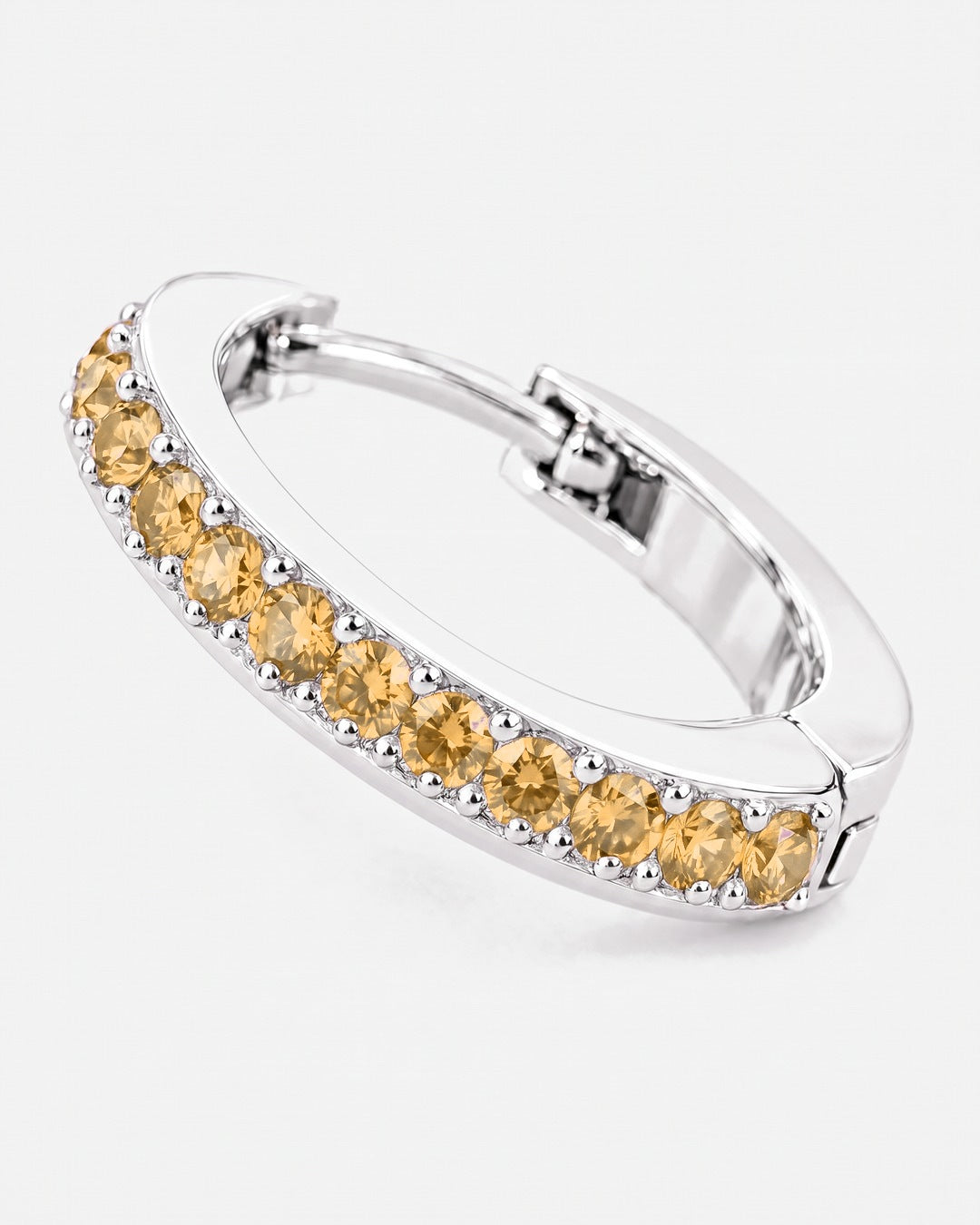 Close-up of the citrine stones on the silver Lumière huggie earring