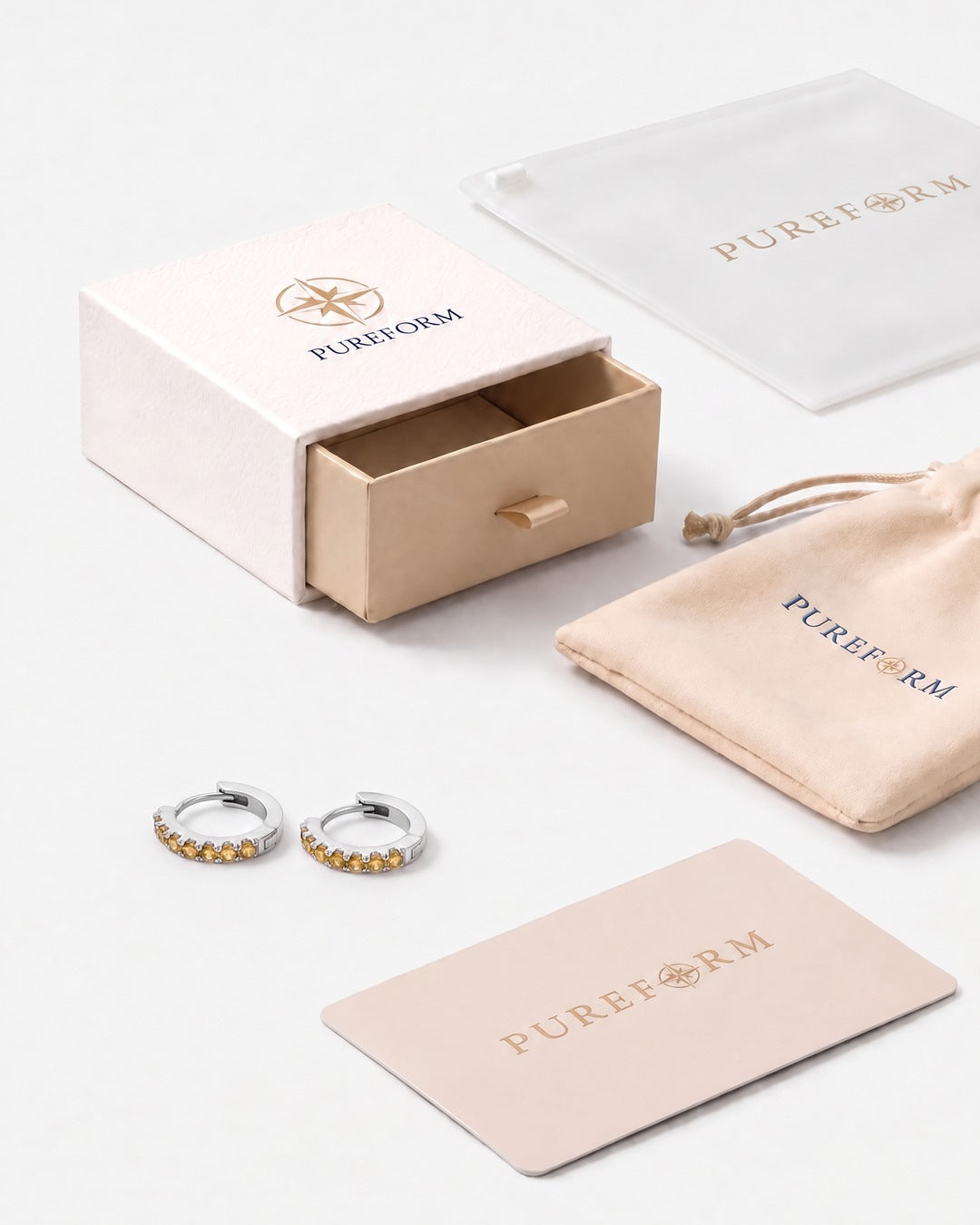 Lumière huggies in citrine silver with Pureform jewelry packaging