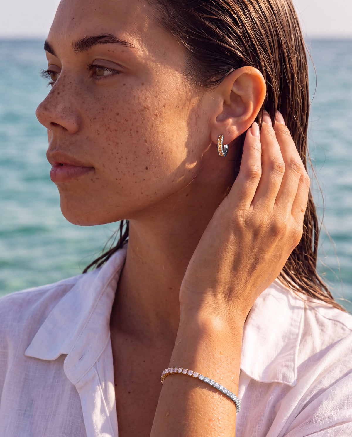 Lumière huggies in citrine silver styled with a tennis bracelet