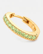 Close-up of the peridot stones on the gold Lumière huggie earring