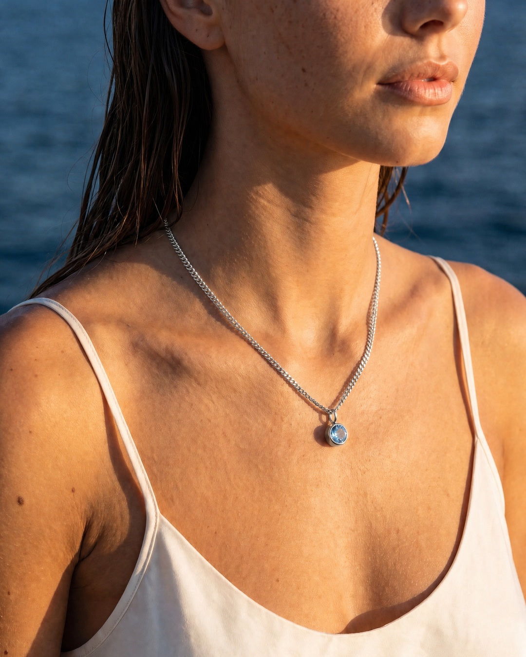 Model wearing the aquamarine silver Lumière necklace