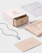 Lumière birthstone necklace in aquamarine silver with Pureform jewelry packaging