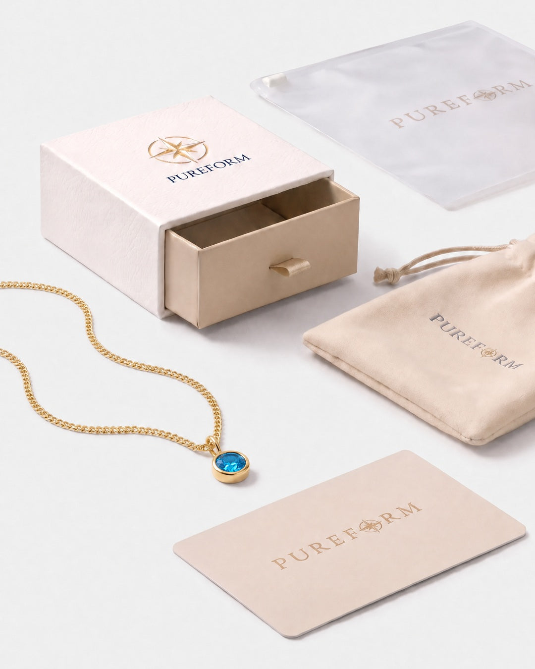 Lumière birthstone necklace in blue topaz gold with Pureform jewelry packaging