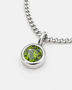 Close-up of the peridot bezel pendant on the silver Lumière necklace