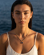 Model wearing the sapphire gold Lumière necklace