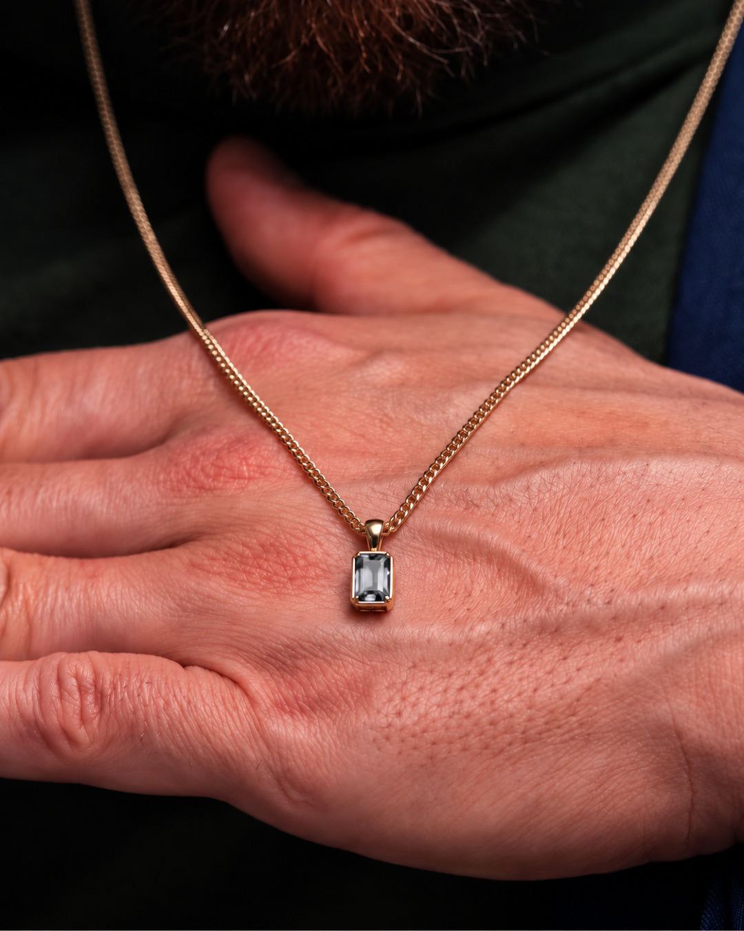 Moissanite pendant necklace, 2 carat, 18K gold — shown in hand for scale