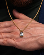 Moissanite pendant necklace, 3 carat, 18K gold — shown in hand for scale