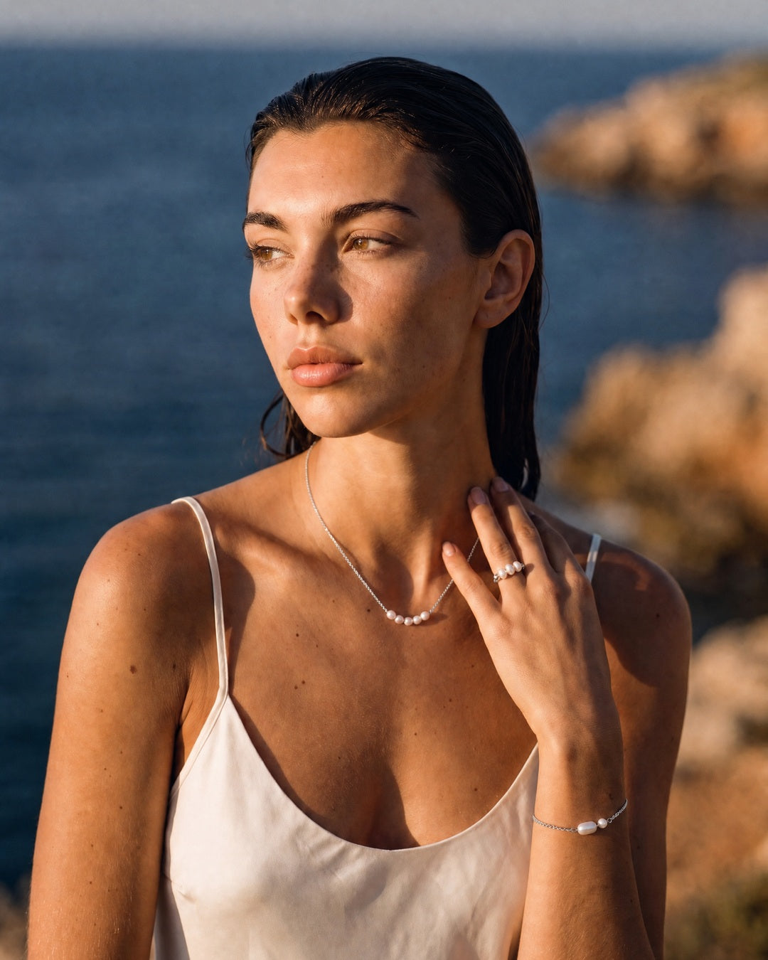 Model wearing the Petite Pearl Necklace silver by the sea