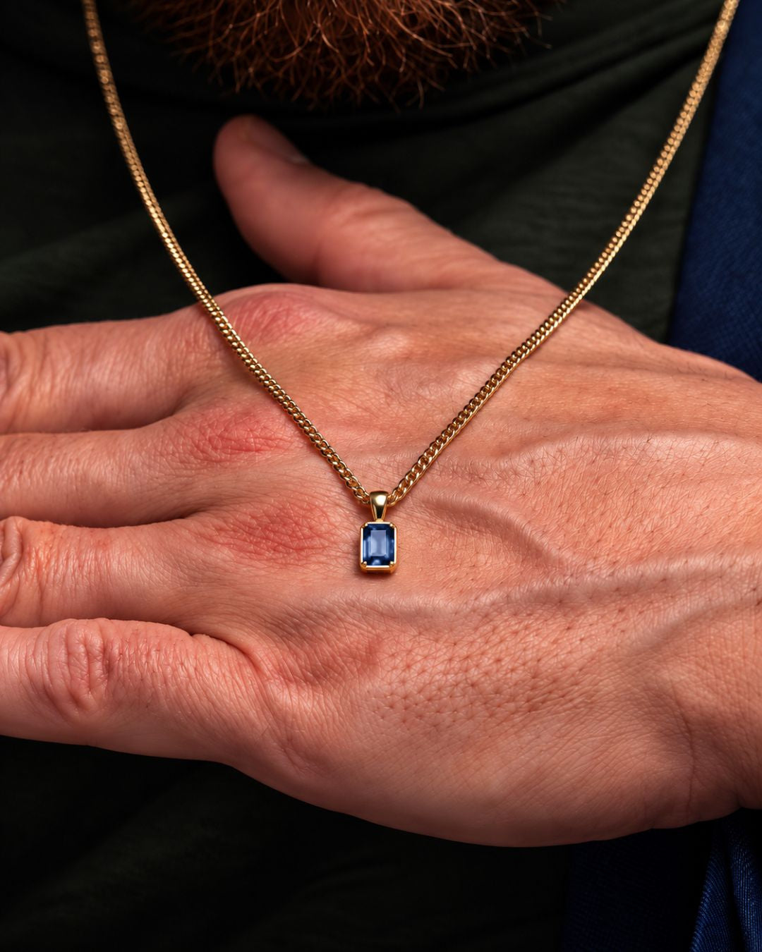 Royal Blue pendant necklace, 1 carat, 18K gold — shown in hand for scale
