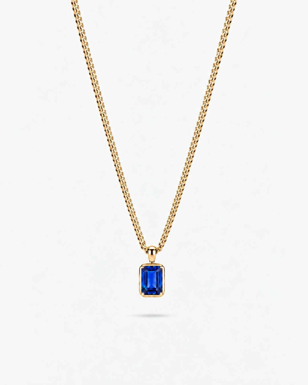 Sapphire pendant necklace, 1 carat, 18K gold — studio packshot on white