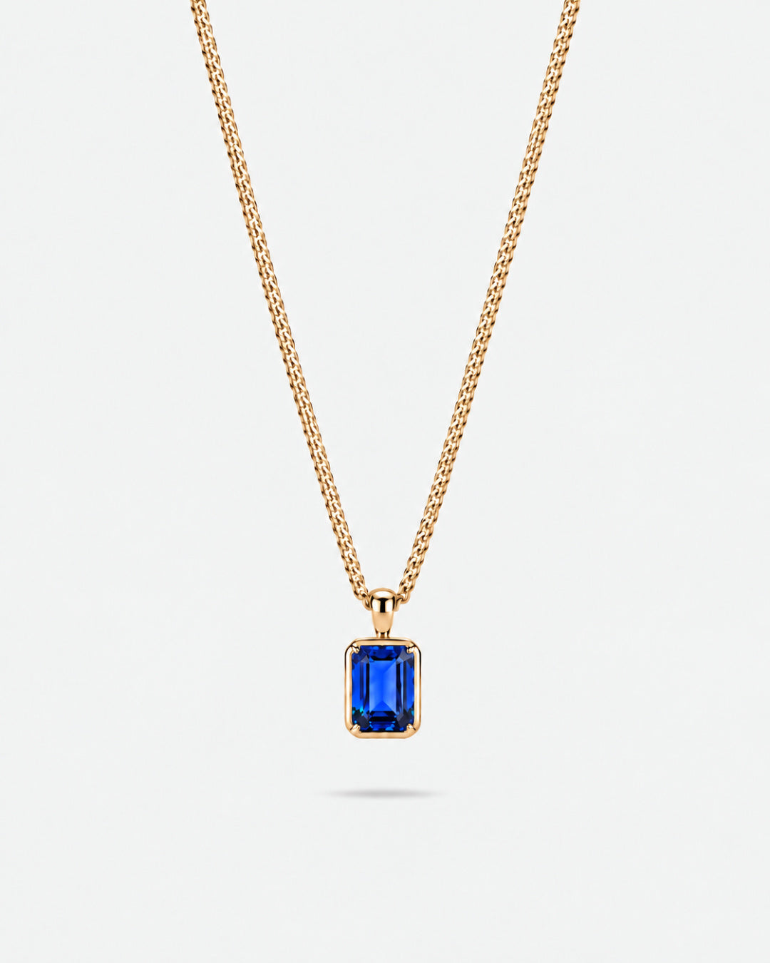 Sapphire pendant necklace, 2 carat, 18K gold — studio packshot on white