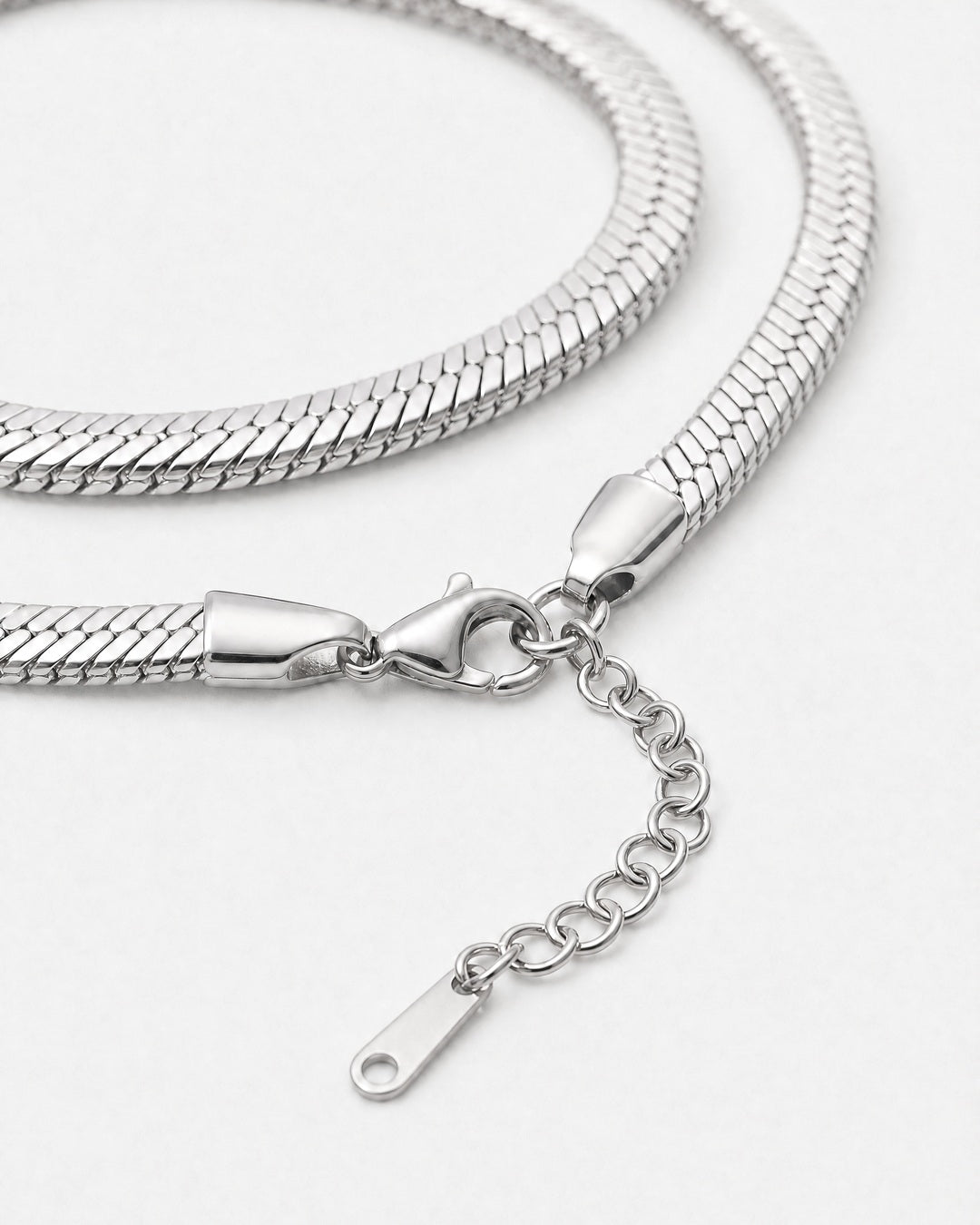 Close-up of the Serpent Flat Necklace in silver showing lobster clasp and extender
